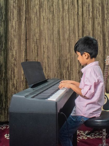A young student plays the piano at our HSR branch open mic.