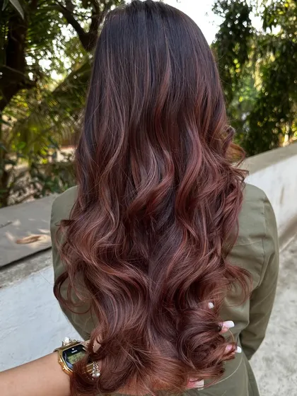 A 'Rose Gold' dream come true. We transformed her faded highlights into this stunning metallic pink shade. It’s a trendy yet sophisticated way to play with color.