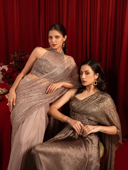 A posed group shot that feels like a still from a classic film. The models are arranged to showcase different outfits from the collection, creating a cohesive and elegant brand statement.