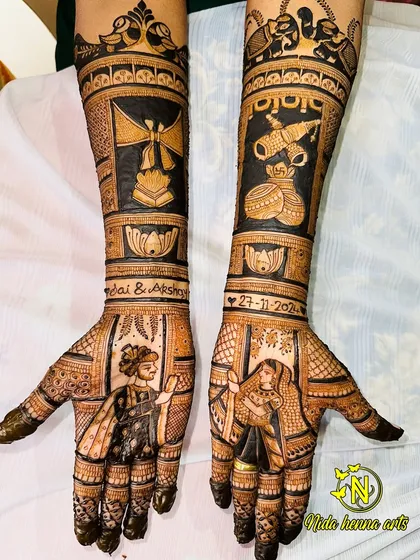 This full-arm design features bride and groom portraits, the wedding date, and symbols representing the couple's story, like the agni kund (holy fire) and shehnai.