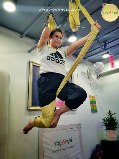 There is a real sense of freedom and play in aerial yoga. This dynamic pose combines strength and balance, showing how the practice can be both a workout and a joyful expression of movement.