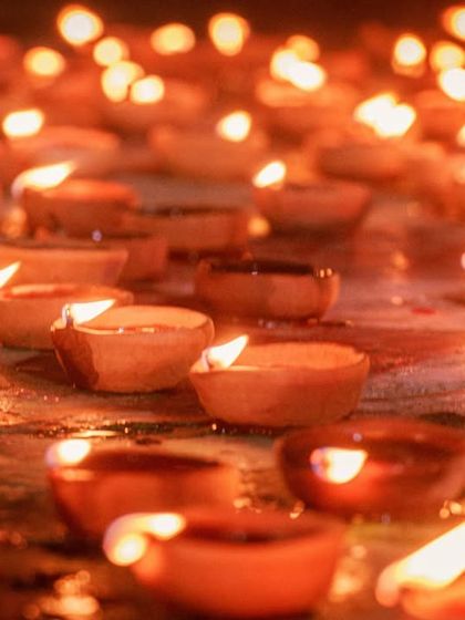 A close-up shot of countless diyas, their flames creating a warm, golden glow. This image symbolizes the light and hope of the festival.