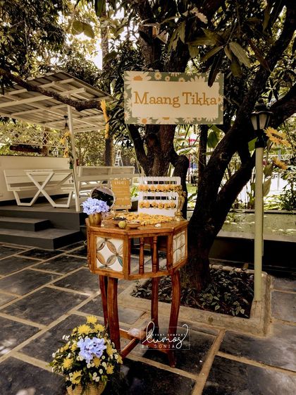 A "Maang Tikka" counter, offering beautiful floral jewelry for guests to wear during the Haldi ceremony.