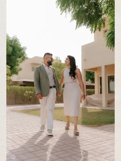 A couple takes a stroll through a beautiful residential area in Dubai. This kind of relaxed, walking shot results in very natural and candid engagement photos.