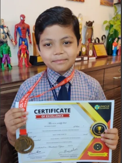 A close up of our champion Reyansh with his certificate of excellence and medal. His achievement in the Mental Math World Cup is a result of his dedication.