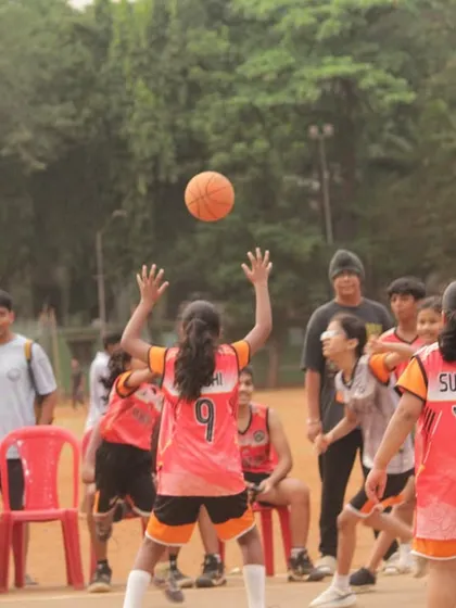 A jump ball in the girls' U-11 game. The focus and determination on their faces say it all.
