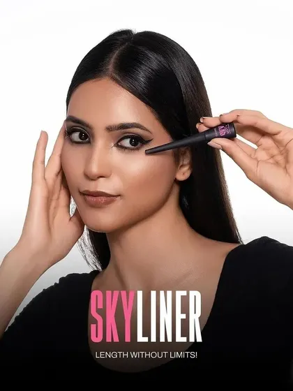 A clean and direct model shot demonstrating the application of the "Skyliner" eyeliner. This type of image is highly effective for showing product use and precision on e-commerce sites and in tutorials.
