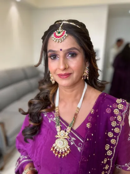 An elegant look for a mature client. The purple smokey eye and traditional jewelry create a regal appearance.