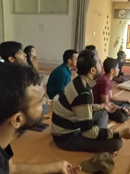A side view of the Sangha during a session. Everyone is focused, creating a unified field of meditative energy in the room.