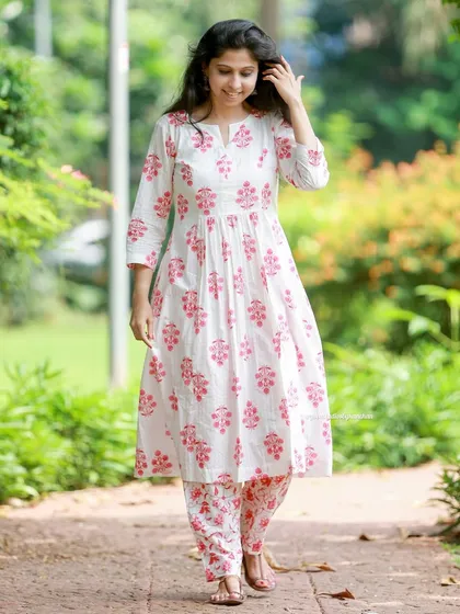 Comfort and style in perfect harmony. This white and pink floral kurta-pant set is a favorite for festive moments.
