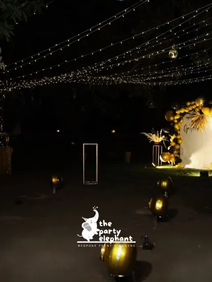 For this milestone 40th birthday, I transformed an outdoor space into a luxe, atmospheric lounge. A canopy of fairy lights, a dramatic black and gold balloon arch, and scattered floor balloons created a sophisticated and magical setting for an evening celebration.