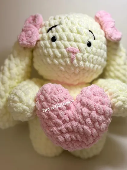My large plushie bunny, shown here holding a soft pink heart, is made with extra-fluffy yarn for a super soft and squishy feel.