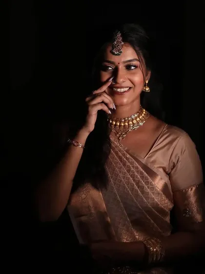 A low-light portrait of a bride on her engagement night. The makeup still looks glowing and defined, proving its longevity and quality.