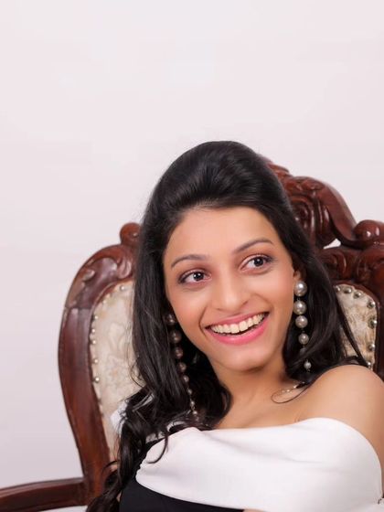 A happy moment from a model's first photoshoot. The makeup is fresh and youthful, perfect for a new face in the industry.