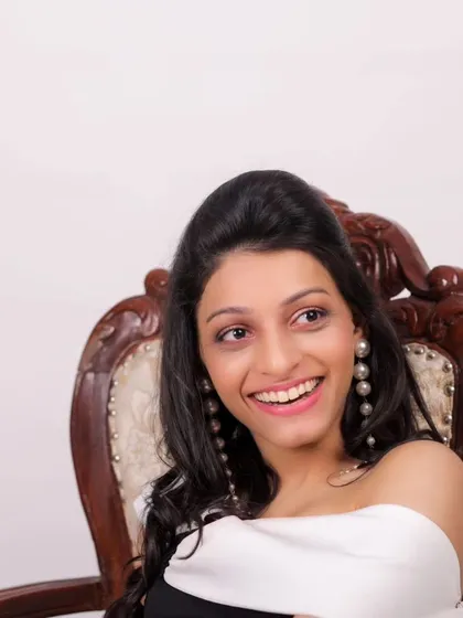 A happy moment from a model's first photoshoot. The makeup is fresh and youthful, perfect for a new face in the industry.