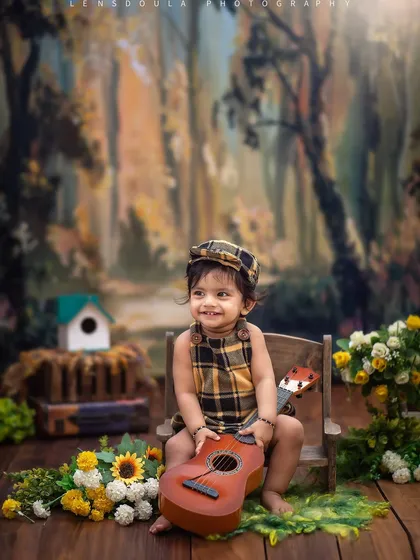 Strumming a little tune. Adding a small guitar to our woodland theme allows for sweet, interactive moments like this one.