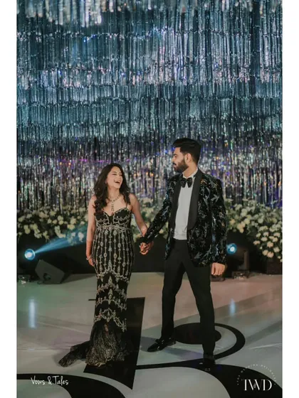 A glamorous couple at their shimmering Sangeet. We created a stunning backdrop of silver tinsel that caught the stage lights beautifully, perfect for a night of dancing.
