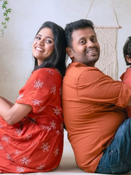 A fun back-to-back pose for the whole family. This playful arrangement makes for a unique and memorable family portrait.