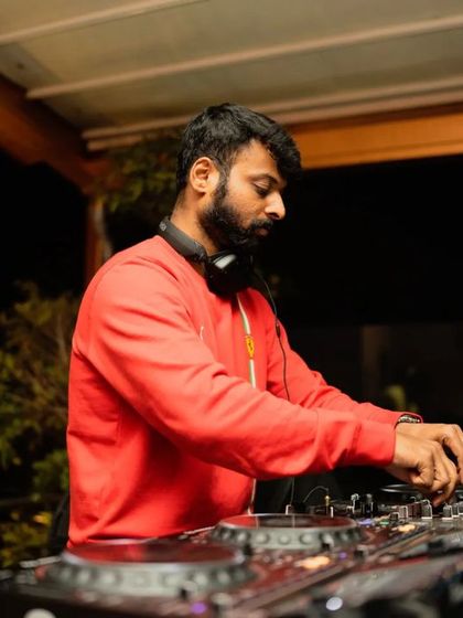 In the zone at Taki Taki, with a red jacket on, focused on the mix.