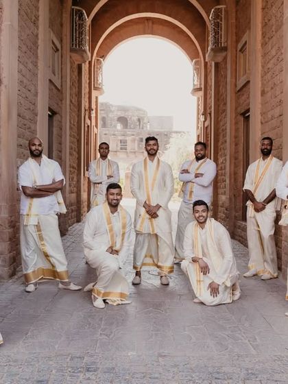 The groom and his groomsmen dressed in traditional South Indian attire for the auspicious Ganesh Puja ceremony.