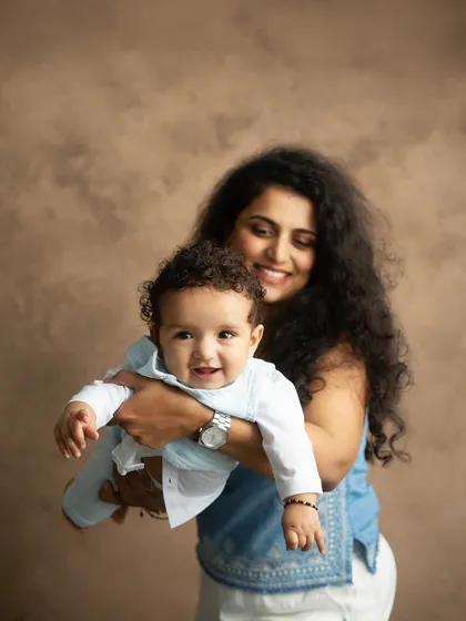 The pure joy of a mother holding her baby. I aim to capture these candid, happy expressions that show the genuine bond you share.