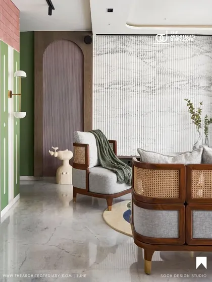 A featured shot showing the living room's blend of textures, from the fluted marble wall to the cane sofa and colorful accents.