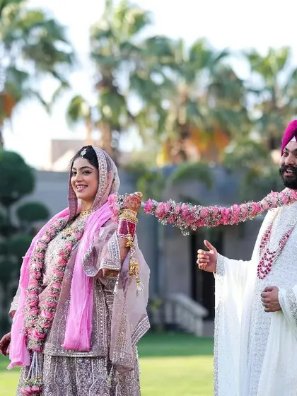 The journey of marriage begins with her playfully dragging him into the pool of forever. A fun, candid moment from a beautiful Sikh wedding ceremony.