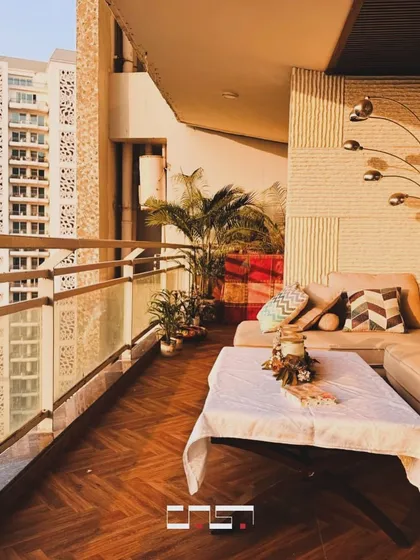 This balcony was designed as a private retreat with a stunning city view. We used warm herringbone wood flooring and a comfortable L-shaped sofa to create a cozy outdoor living area. The space is perfect for enjoying a morning coffee or unwinding at sunset, proving that even compact urban spaces can be transformed into places of peace and 'Sukoon'.