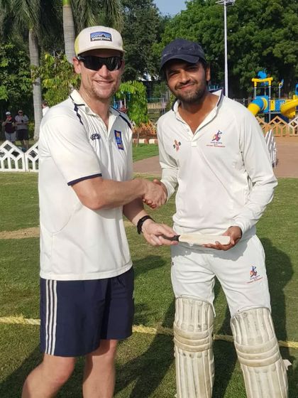 A senior player from my academy shares a moment with a New Zealand cricketer, a great learning experience for him.
