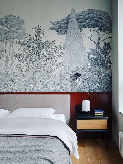Artistic pencil sketches combined with paint are a modern trend for wall highlighting. This design uses a beautiful nature-inspired mural to create a serene and artistic bedroom wall.