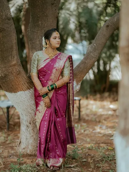 A full-length shot showing the grace of this Marathi bride. Her entire look, from the elegant saree to the flawless makeup, creates a picture of timeless tradition.