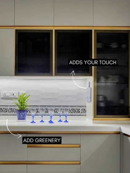 Even a functional space like a kitchen can have personality. I used fluted glass cabinets and a patterned tile border to add visual interest, while the pop of blue from the glassware brings a touch of playfulness to the clean, modern design.