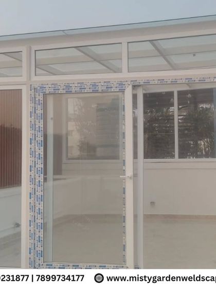The WPC louvers are part of a larger terrace enclosure, providing privacy for one section while glass panels keep other areas open.