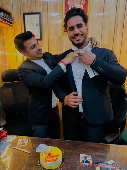 Helping my 'chotebhai' with his advocate's bands. It's a proud moment to guide a new lawyer.