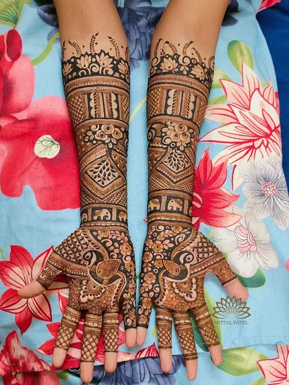 A lovely example of a non-figure bridal mehndi. This design uses peacocks, elephants, and floral bands to create a full, traditional look without portraits.