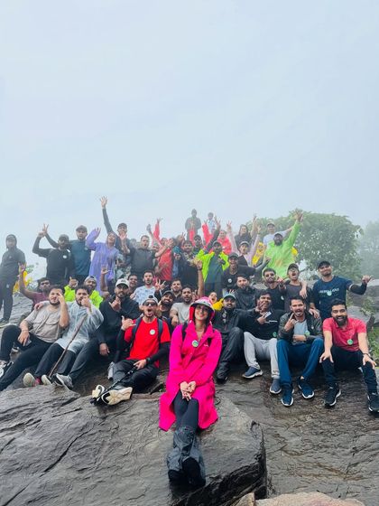 Posing on the rocks at the summit. The fog adds a layer of mystery to the landscape.