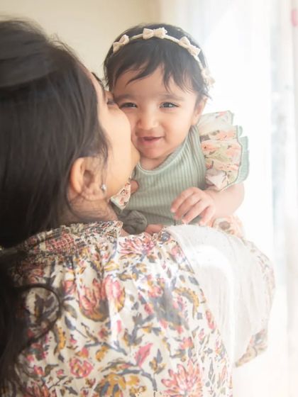A sweet kiss for her little one. These are the natural, loving interactions that make for the most beautiful and meaningful family portraits.
