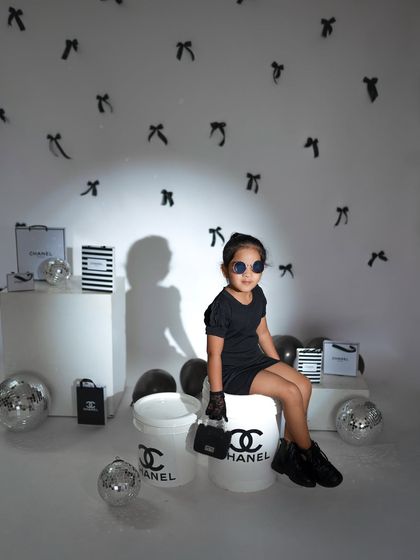 A direct-to-camera pose from the older sister, showing her confidence and personality.