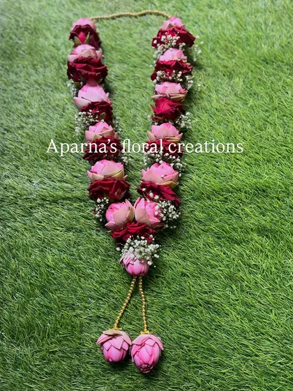 I combined pink lotus buds with deep red roses in this custom varmala. The contrast in color and texture makes it a unique and eye-catching piece for any ceremony.