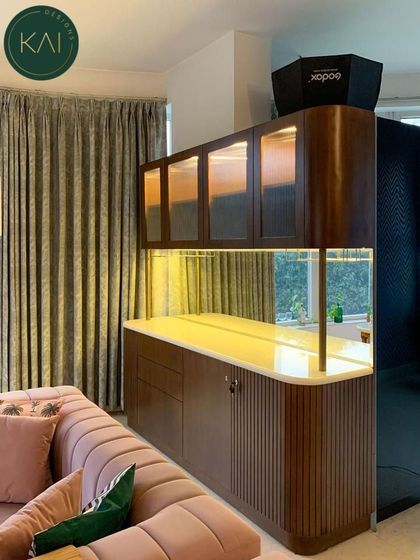 A view of the custom bar and crockery unit with its integrated lighting turned on, creating a warm and inviting ambiance in the evening.