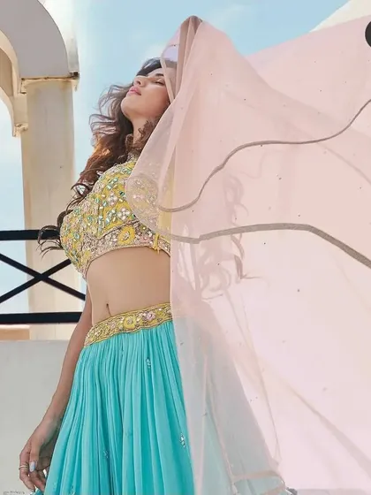 My makeup is designed to look amazing in any light, especially outdoors. This shot from a pre-wedding shoot shows how the makeup stays fresh and vibrant under the sun. The flowing dupatta adds a dynamic feel, and the makeup complements the bright, happy mood perfectly.