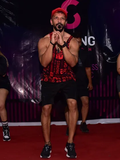 Leading a Strong Nation masterclass on stage in Vadodara, the first stop of our India tour. You can see the intensity and focus as we guide the class through a challenging, beat-driven routine.
