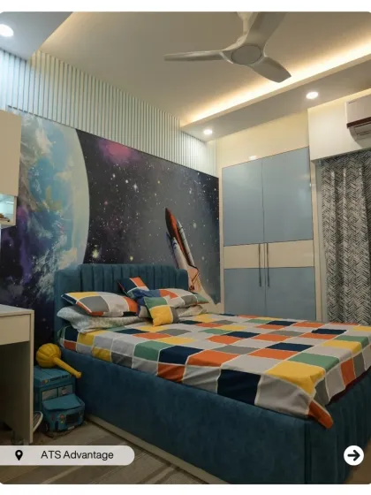 An out-of-this-world bedroom for a space enthusiast. The accent wall features a stunning galaxy and rocket mural, making the room a launchpad for dreams.