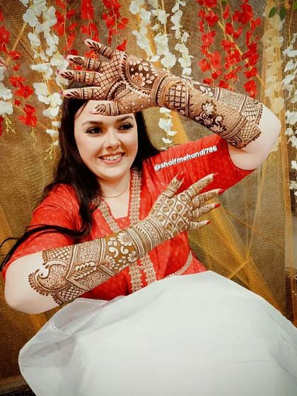 Another joyful bride posing with her stunning, full-coverage bridal mehandi. Capturing these moments is priceless.
