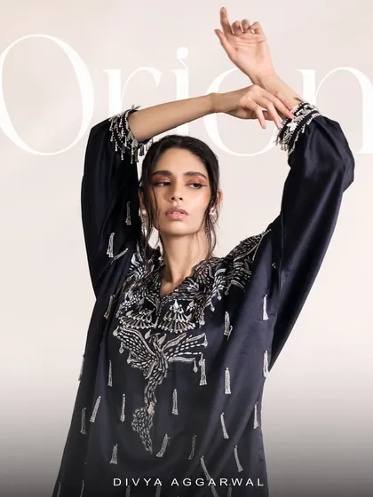 An artistic shot of the Orion Kaftan Set, capturing the movement and grace of the sumptuous silhouette and tassel details.