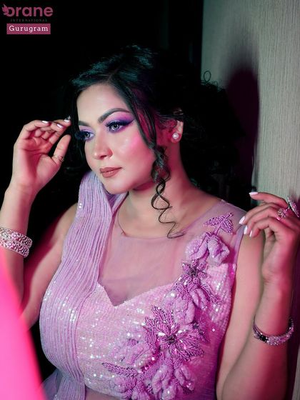 Another creative shot using pink lighting to enhance the purple tones of the makeup and dress.