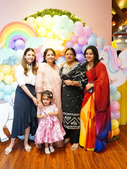 A multi-generational family photo in front of the unicorn balloon wall. Our parties are a wonderful occasion for the whole family to celebrate together.