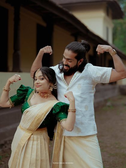A fun and quirky portrait of the couple flexing their muscles, showcasing their playful personalities and strong partnership.