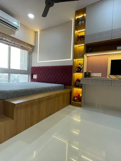 Smart design is about making every inch count. This children's bedroom features a custom-built elevated bed with an integrated study nook and illuminated shelves, creating a multi-functional space that is both playful and practical.