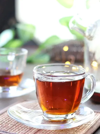 A close-up on a single cup of tea, with the steam and background bokeh creating a warm and inviting feeling.